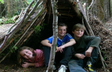 Three chidren in a den or bivy